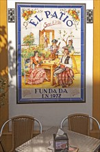 Ceramic tile picture of traditional folk musicians at El Patio restaurant, Triana district,