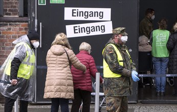 Vaccinees report at the entrance to the vaccination centre in the Arena in Treptow, Berlin, 09.02