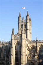 English flag flying on the tower of the Abbey church, Bath, Somerset, England, UK