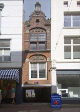 Narrow building appearing to have been squashed Dordrecht, Netherlands passage beneath to harbour