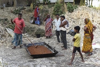 Workers making Gur (jaggery) in a village on December 10, 2021 in Barpeta, Assam, India. Gur