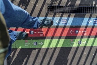 Signpost on the pavement, for bus and train diversions at Dortmund Central Station, during