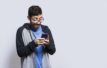 Person smiling and using cell phone isolated, person in glasses smiling using smartphone on