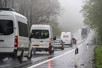 Traffic on a country road in the rain, B229, spring, near Radevormwalde, Oberbergischer Kreis,