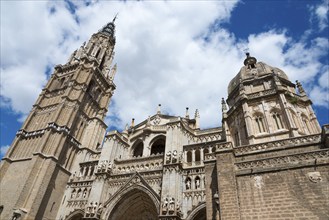 Gothic cathedral with richly decorated towers and stone architecture under a blue sky, Cathedral,