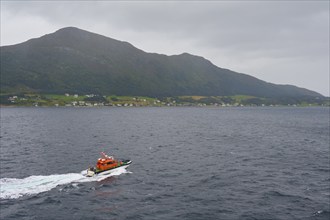 Pilot boat at sea, entrance to Alesund and island in the background, Alesund, Fylke, Norway, Europe