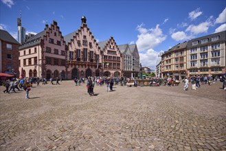 Town hall square Römerberg with town hall under blue sky with cumulus clouds in Frankfurt am Main,