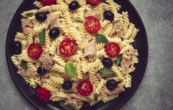 Tuna salad, fusilli pasta, olives and cherry, olive oil, homemade