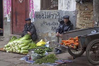 Chinese vendors selling vegetables on the street in the city Zhaotong, Yunnan province, China, Asia