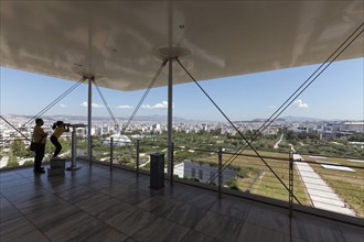 Visitors on the viewing terrace, view of the landscape park and Athens, cultural centre of the