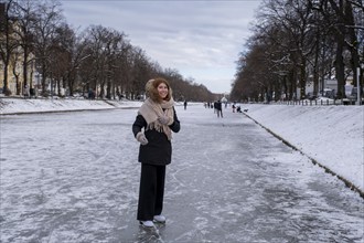 Ice skaters on the Nymphenburg Palace Canal, Nymphenburg in winter, Munich, Upper Bavaria, Bavaria,