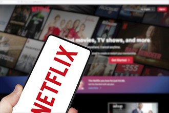 Netflix logo online video streaming platform on a mobile phone and computer in Stuttgart, Germany,