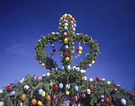 A traditionally decorated Easter tree with colourful Easter eggs under a clear blue sky, Franconian