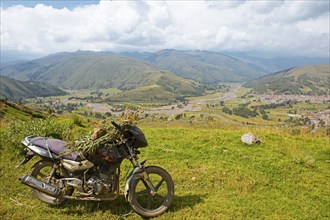 View of the Combapata district and the Rio Vilcanota in the Andean highlands, in front a motorbike,