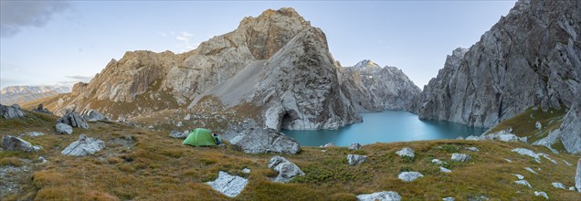 Wild camping, camping in the wilderness with a tent in front of mountain lake Kol Suu, Sary Beles