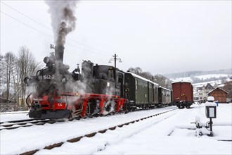 Steam train of the Preßnitztalbahn railway Steam locomotive in winter in Steinbach, Germany, Europe