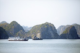 Excursion boats and karst rocks in Lan Ha Bay, Halong Bay, Vietnam, Asia