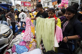 People buys clothes at a street market ahead of Durga Puja festival on October 7, 2024 in Guwahati,