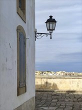 Street lamp on the corner of a house, old town centre, Otranto, Apulia, Italy, Europe