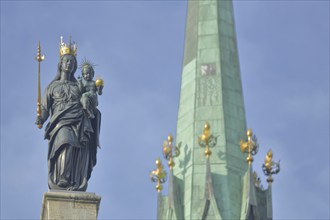 Madonna figure with golden crown and blurred spire of Our Lady, Minster, sceptre, baby Jesus, arm,