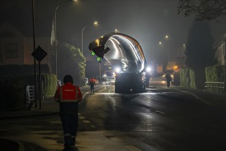 Transport of a 68 metre long, 22 tonne blade of a wind turbine, here in Breckerfeld, with a