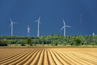 Wind turbines on the Grevenbroich wind test field, dark rain clouds, in the Rhenish lignite mining