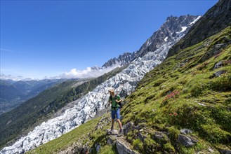 Hiking on the trail to La Jonction, Glacier des Bossons, behind the summit of the Aiguille du Midi,