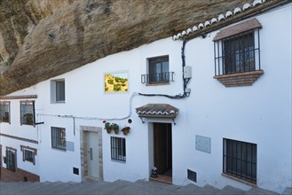 White houses in Setenil de las Bodegas, rocky overhang, sunny sky, cave dwellings, Setenil de las