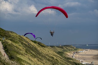 Paragliders along the dunes of Zoutelande, in Zeeland, South Holland, Netherlands