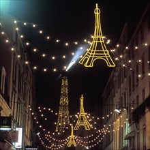 Christmas lights with the Eiffel Tower in the background, Paris, France, Europe