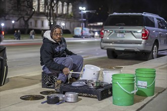 Detroit, Michigan - A street musician performs on his pots and pans on Noel Night. The annual event