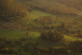 Volcanic embryo Hohbölle near Beuren. Autumnal Swabian Alb at sunset