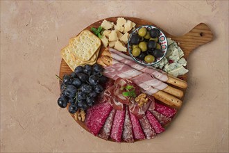 Appetizer, assortment, set, sausage, and cheese, on a wooden board, top view, no people