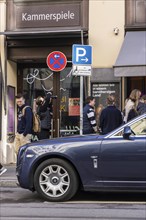 Disabled parking space in front of a trendy bar on the fashionable shopping street Maximilianstraße