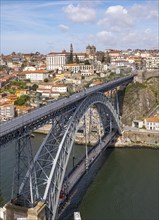 The iconic Dom Luís I Bridge spans the Douro River, with Ribeira district in the background, Porto,