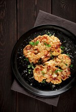 Steak, cauliflower, with cheese, spices, homemade, on a wooden table, dark background, close-up,