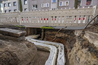 Construction site of a district heating house connection, pipes, insulated, are laid from a central