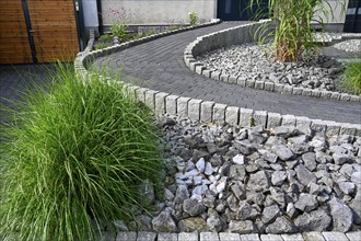 Modern front garden with paved path and stones, gravelled garden, Ruhr area, North