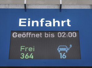 Display board at a public car park, showing free parking spaces for electric cars, North