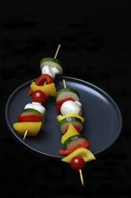 Colourful vegetable skewers on a plate, barbecue skewers