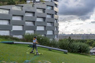 CopenHill, waste incineration plant and artificial ski slope, skiing with a view of the ski lift,