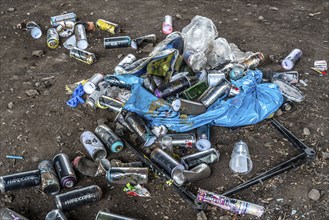 Paint cans, leftover rubbish from graffiti sprayers, under the motorway bridge, the A43 over the