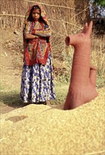 Girl from the Garasia tribe in Gujarat, India. She is standing near the representation of a horse