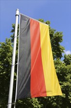 German national flag in front of a blue sky