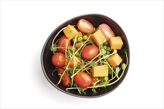 Vegetarian vegetable salad of tomatoes, pumpkin, microgreen pea sprouts isolated on white