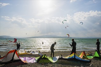 Kitesurfers and windsurfers in sun and storm, Reichenau Island, Untersee, Lake Constance,