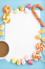 Composition with candies frame on blue pastel background. copy space, top view, flat lay, template