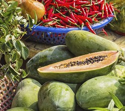 Ripe papaya and red pepper on the market