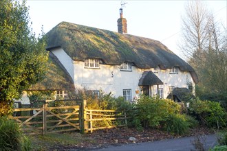 Attractive traditional thatched cottage in village of Manningford Bruce, Wiltshire, England, UK