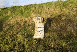 Old milestone road marker on A4 road Beckhampton, Wiltshire, England, UK